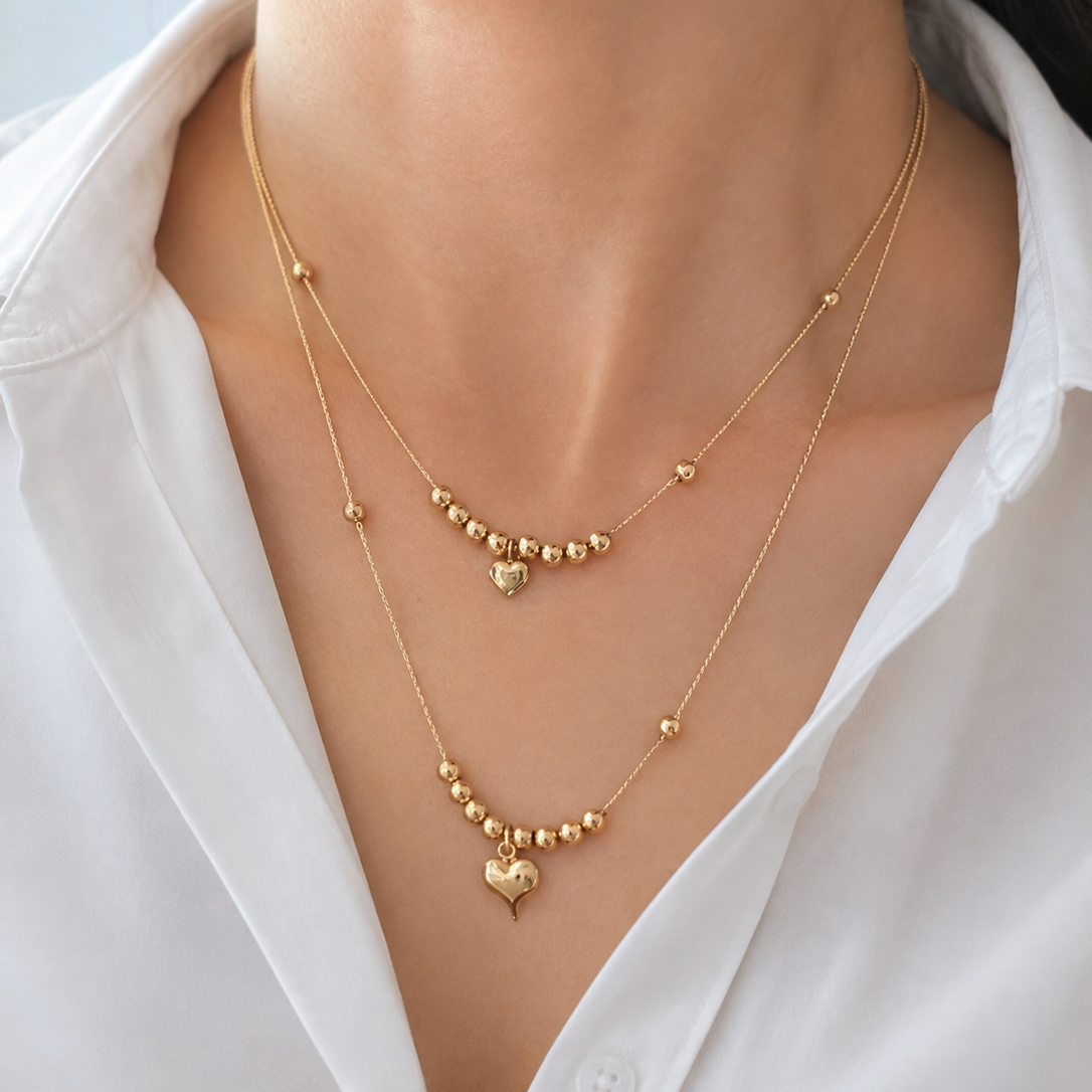 Collar doble esfera y corazón en dorado